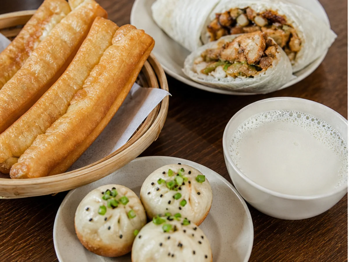 Shanghai breakfast table with soy milk, youtiao, cifan tuan, and buns