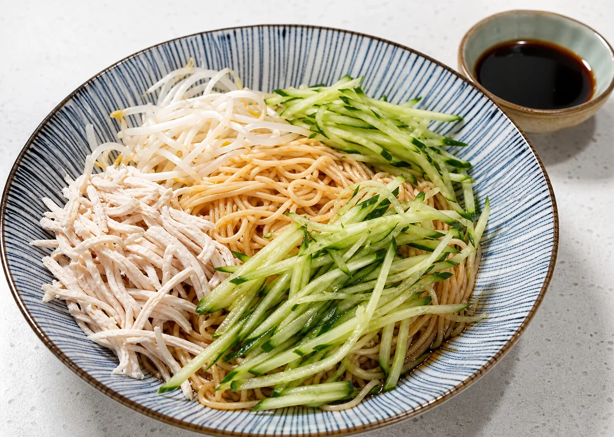Shanghai cold noodles with shredded chicken, cucumber, bean sprouts, and vinegar