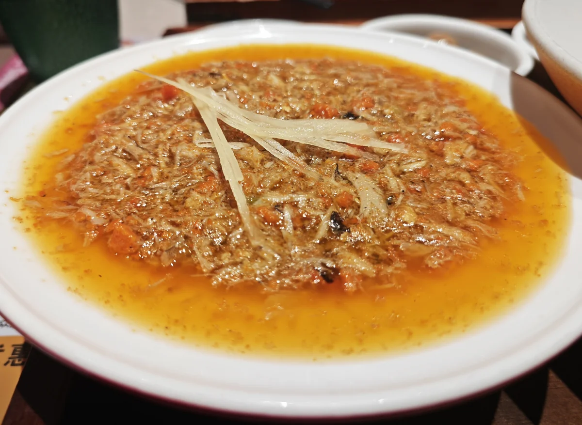 Bowl of crab roe noodles with golden crab topping