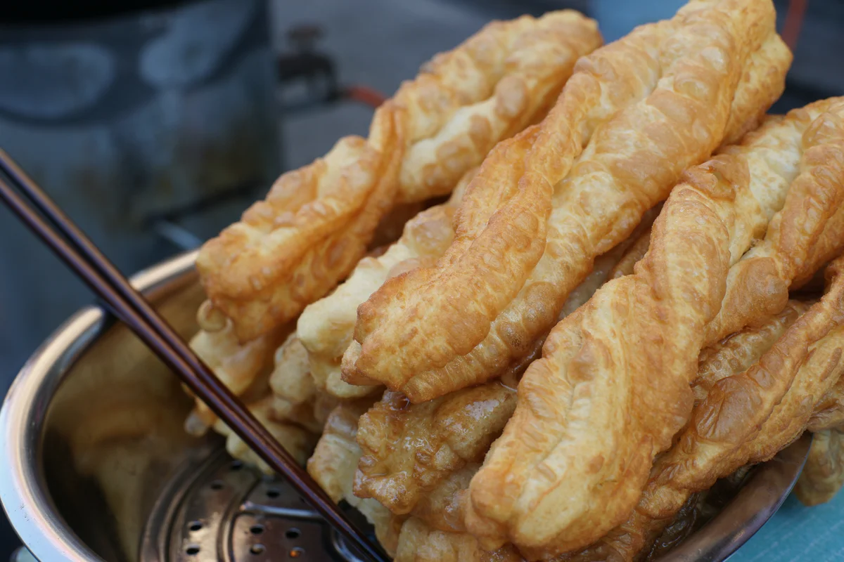 Fresh youtiao fried dough sticks with crisp bubbled texture