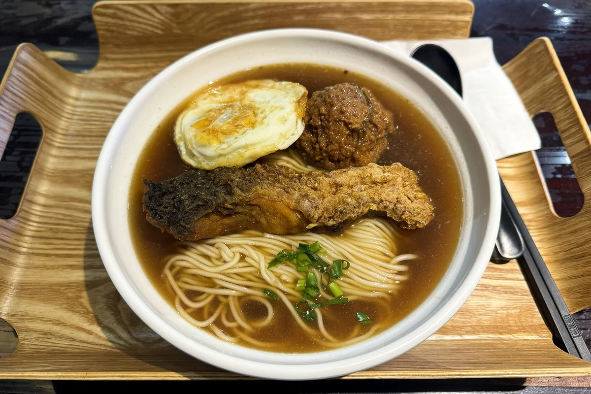Shanghai-style smoked fish served with soup noodles and lion head meatball