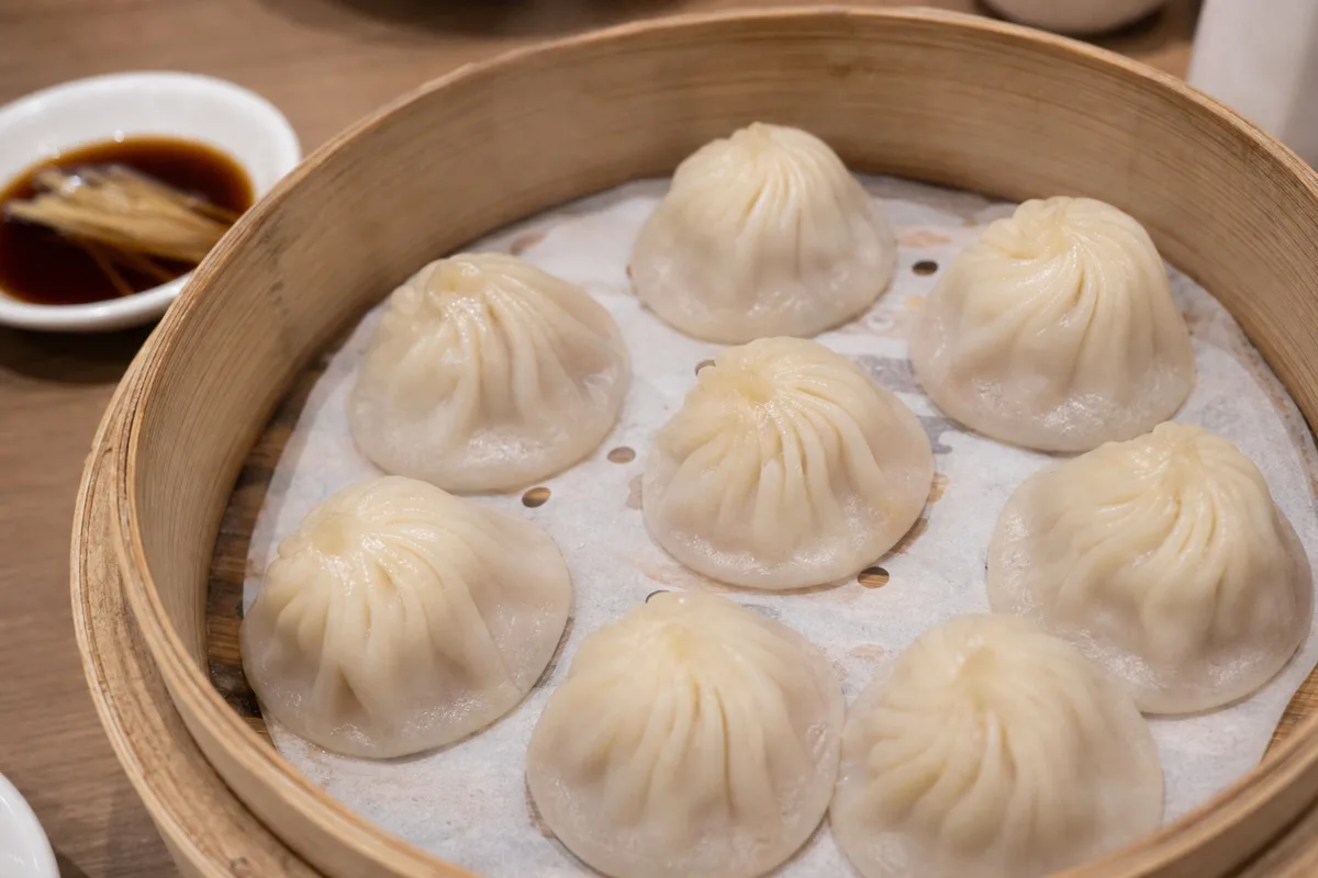 Shanghai xiaolongbao served with dark vinegar and ginger shreds