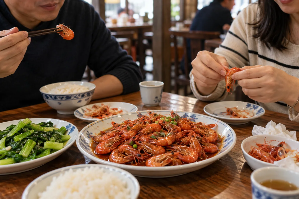 Diners peeling and sharing Shanghai quick-fried shrimp with rice and greens